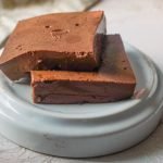 Closeup of chocolate gelatin squares on plate.