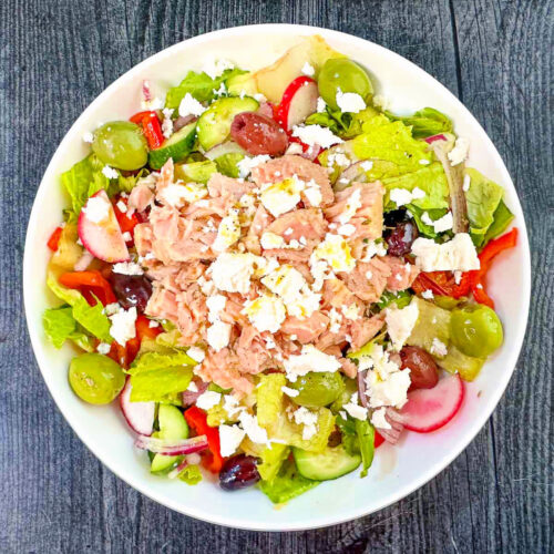 Aerial view of white bowl with Greek tuna salad.