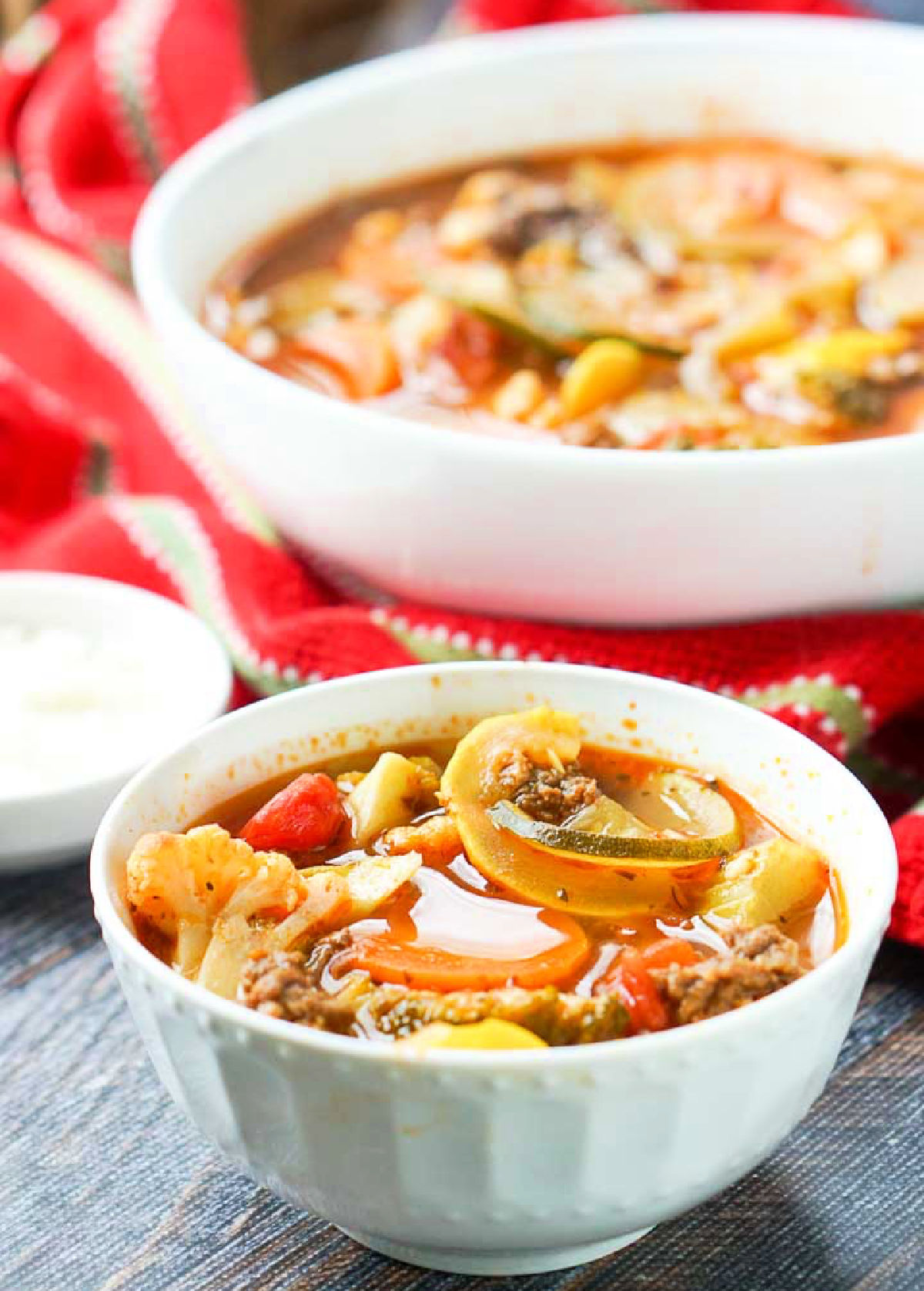 Two white bowls with the low carb Italian vegetable soup.