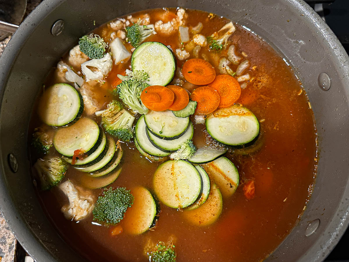 Soup pot with the veggies and broth ingredients added.