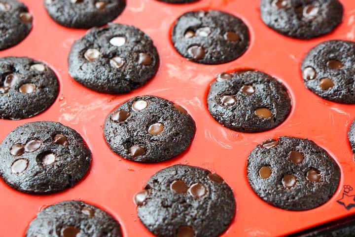 red muffin tin with baked chocolate low carb muffins with chocolate chips