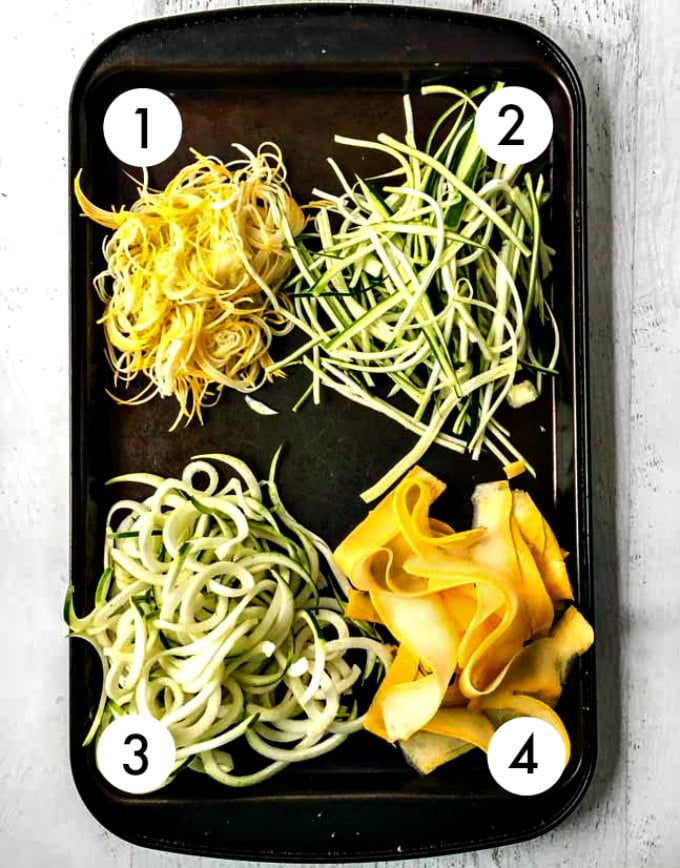 Raw veggie noodles using different sizes on a baking tray.