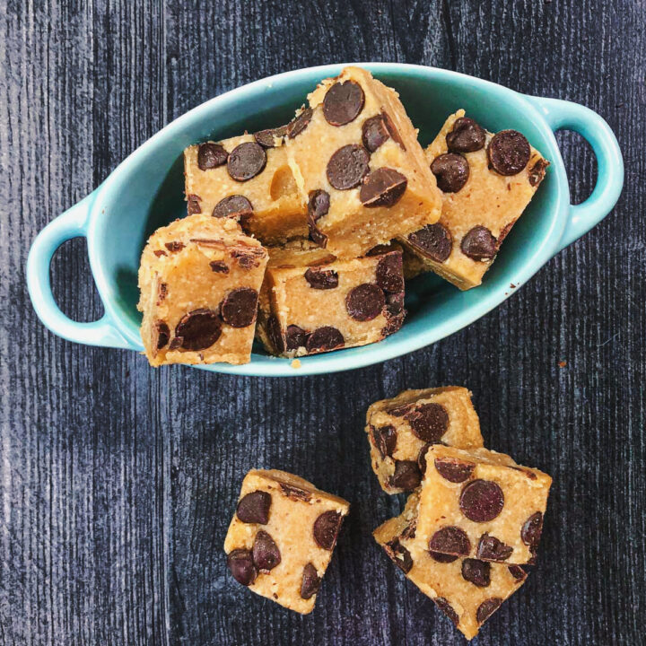 blue dish with pieces of healthy cookie dough fudge pieces