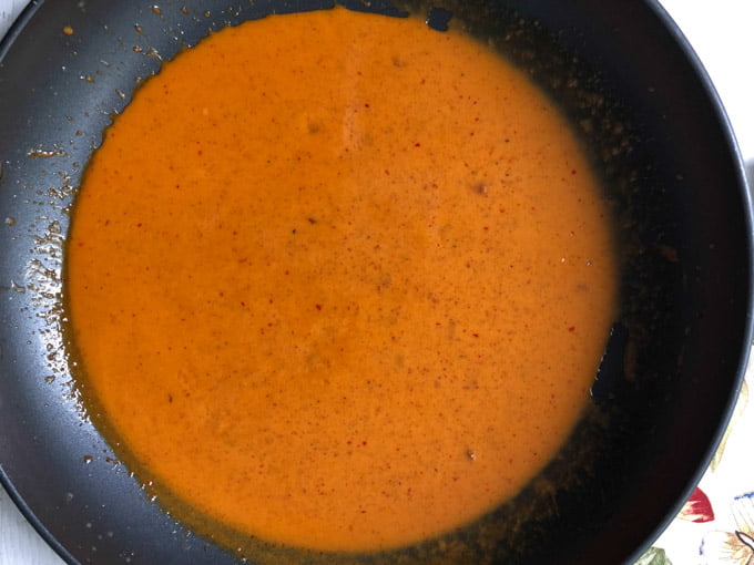 skillet with red curry sauce