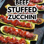 A baking sheet with Middle Eastern ground beef stuffed zucchini and text.