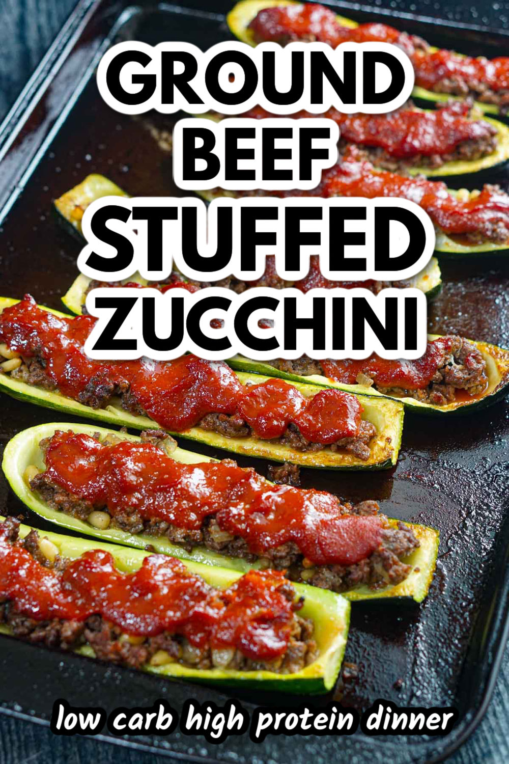 A baking sheet with Middle Eastern ground beef stuffed zucchini and text.