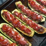 A baking sheet with Middle Eastern ground beef stuffed zucchini.