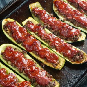 A baking sheet with Middle Eastern ground beef stuffed zucchini.