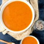 big and small bowls with red pepper and sweet potato soup and text