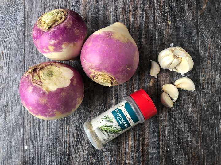 3 purple raw turnips, cloves of garlic and a bottle of rosemary