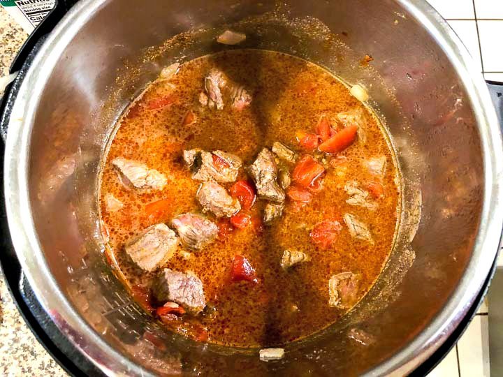 instant pot full of beef curry ready to pressure cook