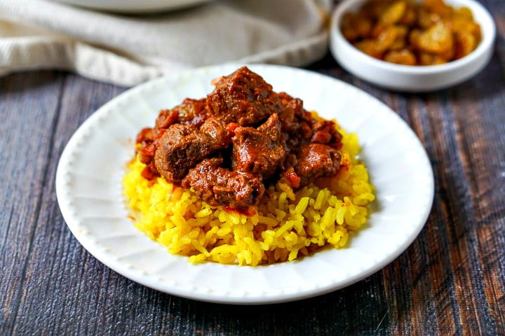 white plate with yellow rice and easy beef curry made in the Instant Pot 