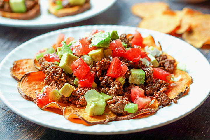 close up of healthy paleo nachos on a white plate