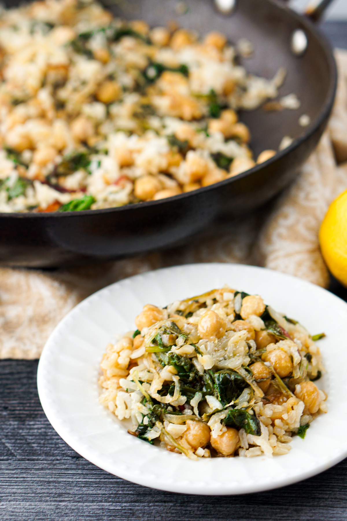 pan and white plate with lemony greens, chickpeas and rice