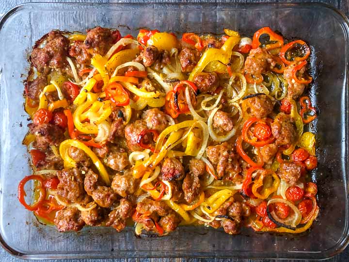 baking dish with roasted peppers, tomatoes, onions and Italian sausage