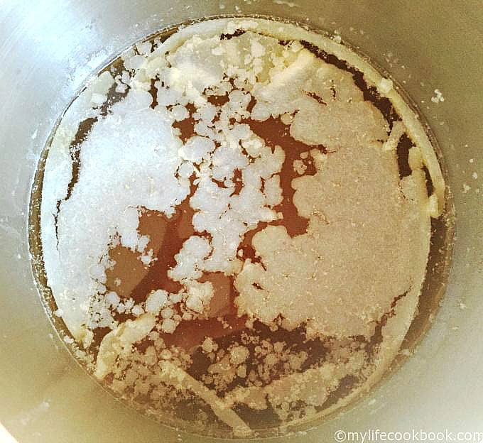 closeup of a soup pot with ham stock and the fat has hardened from refrigerating it. 