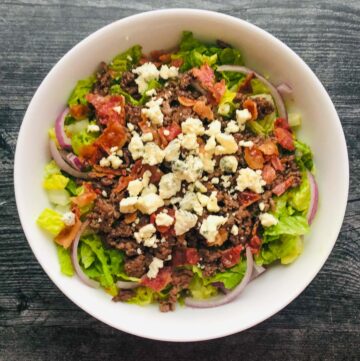 white bowl with bacon blue cheese burger salad