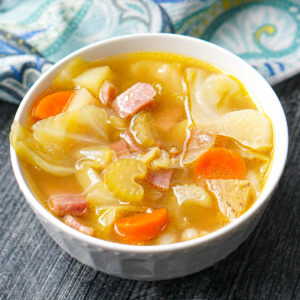white bowl with ham and cabbage soup