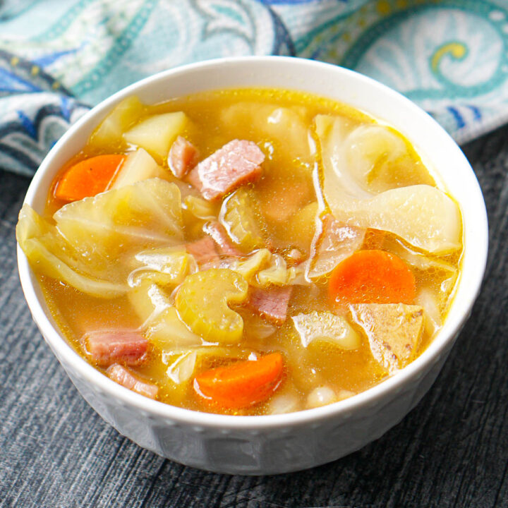 white bowl with ham and cabbage soup