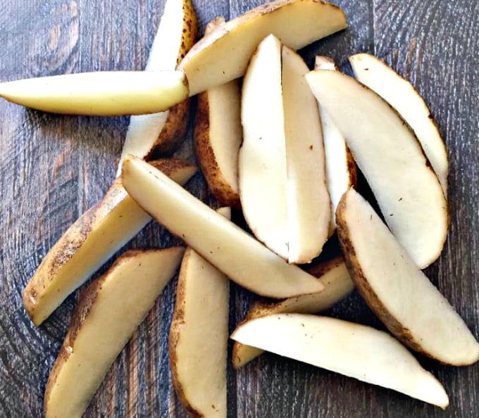 raw potato cut up into steak fries 