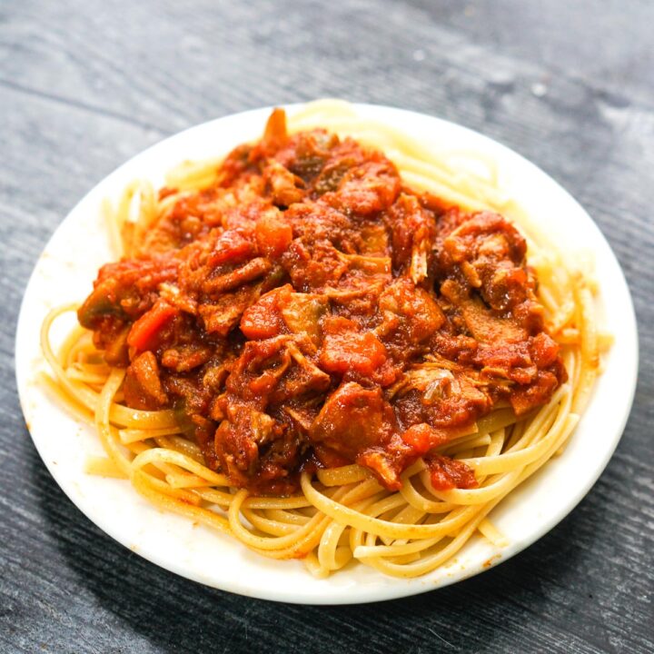 white plate with a pasta topped with an easy pork ragu recipe