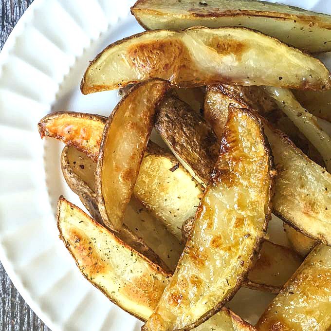 close-up of crispy perfect steak fries on white plate