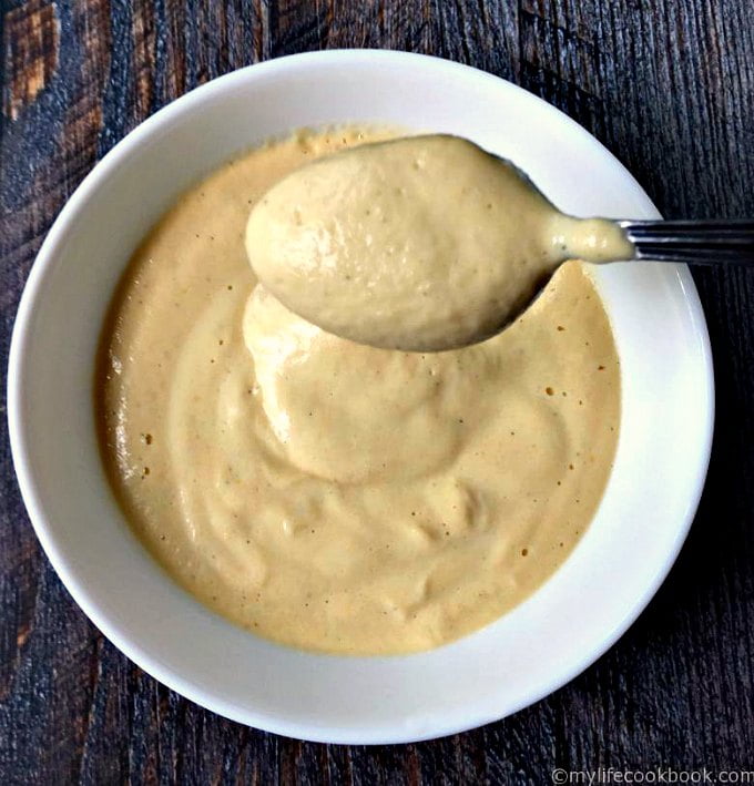 bowl of cauliflower cheese sauce in a white bowl