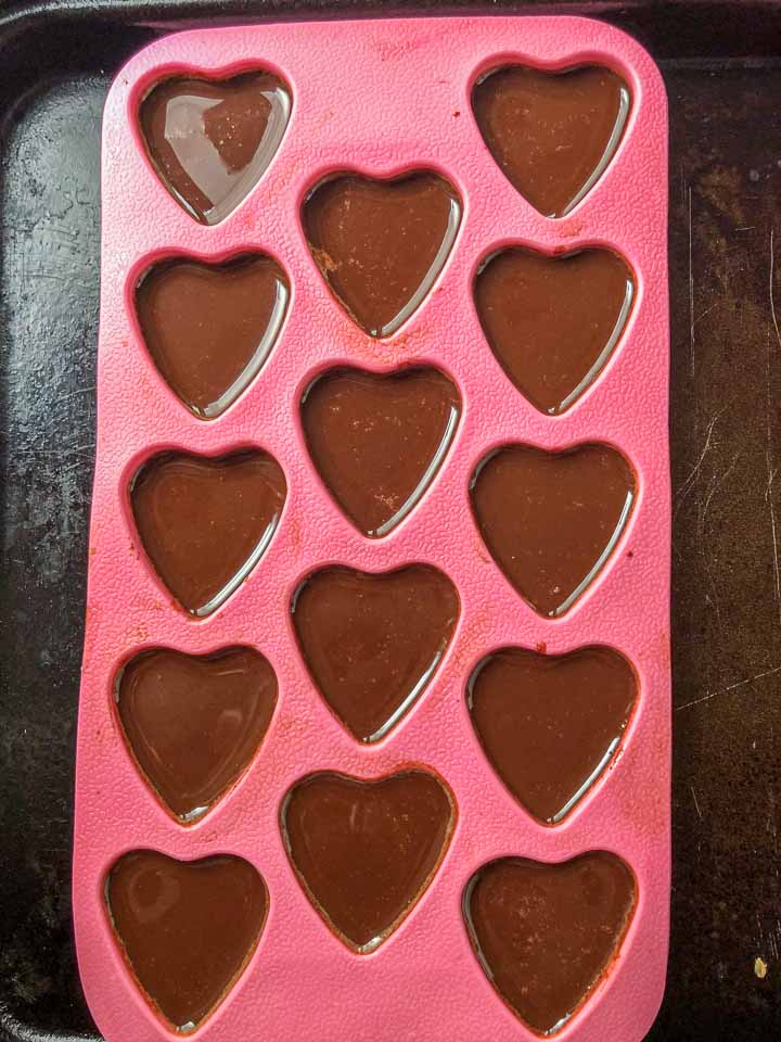 pink heart mold with low carb chocolate candies just poured