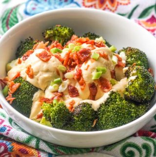 white bowl of broccoli with cheese sauce and bacon