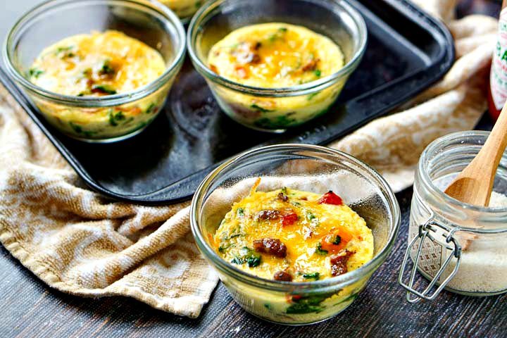 glass custard cups with omelets in them and cookie sheet in background and jar of salt