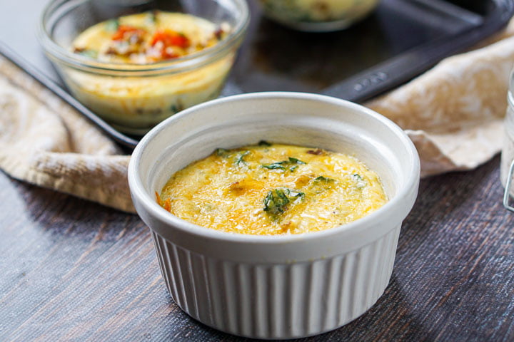 ramekin with the omelet and some glass cups full of omelet in the background