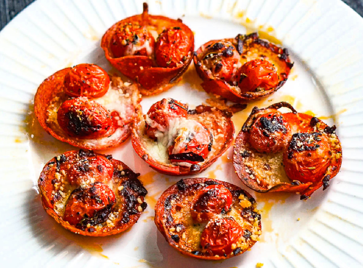 Closeup of a plateful of keto pepperoni pizza cups.