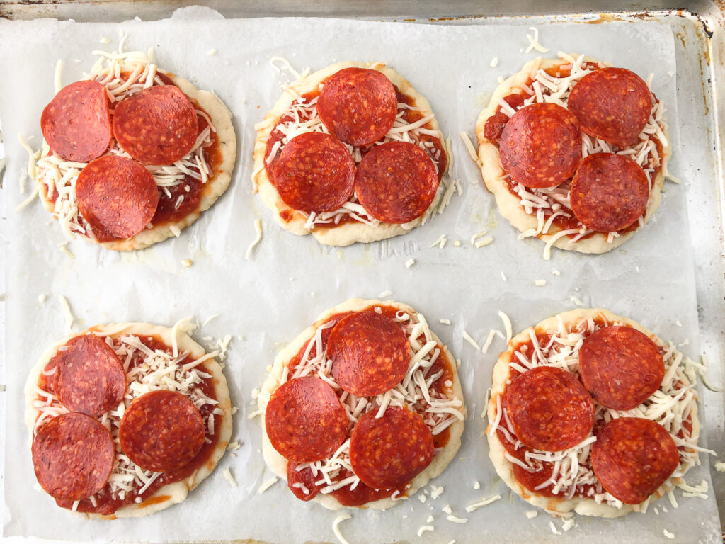 baking sheet with 6 precooked pepperoni mini pizzas ready to bake or freeze