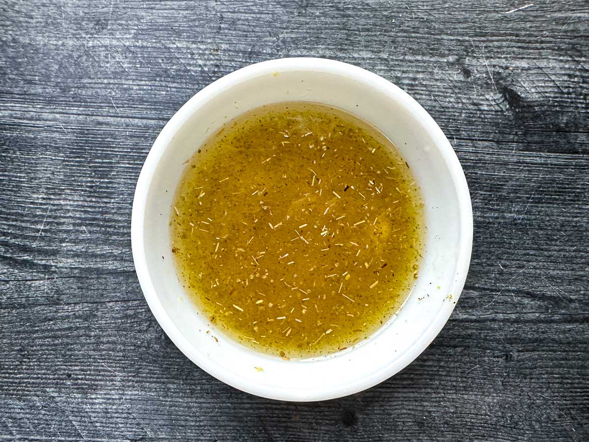 White bowl with low carb Greek marinade.