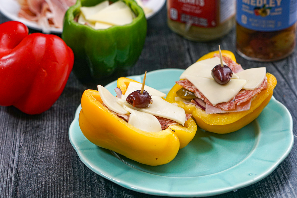 Closeup of a yellow pepper stuffed with meats and cheeses.