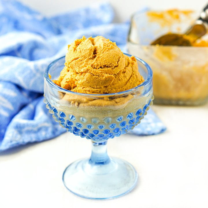 blue glass dish with a scoop of low carb pumpkin blender ice cream