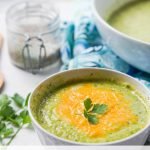 bowls of zucchini soup with cheese with text overlay