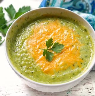 white bowl with low carb zucchini soup with cheese on top