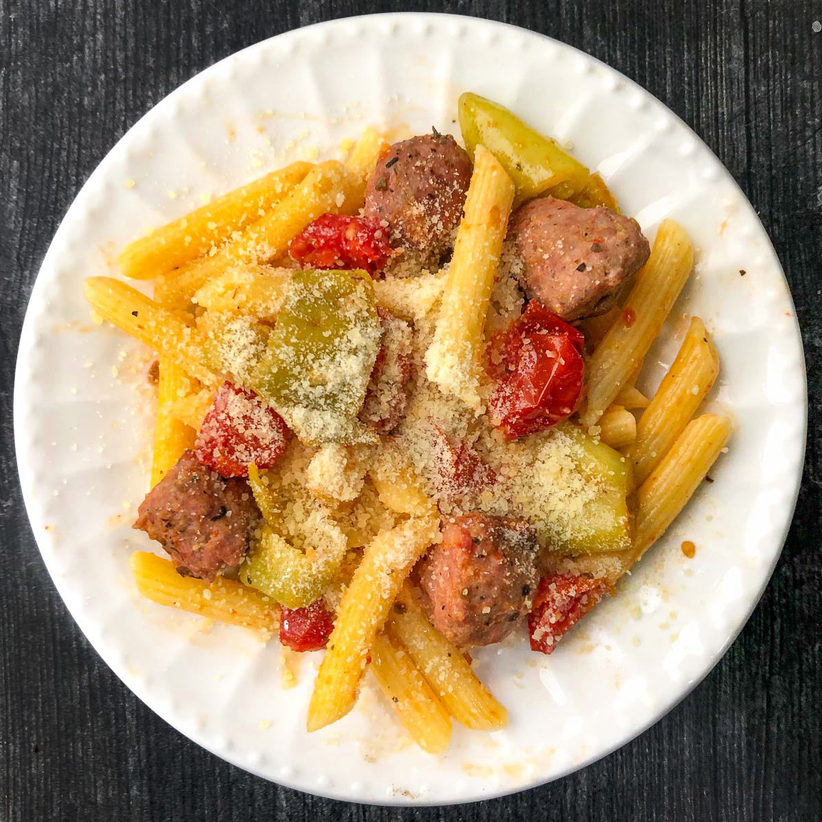 white plate with sausage and banana pepper pasta