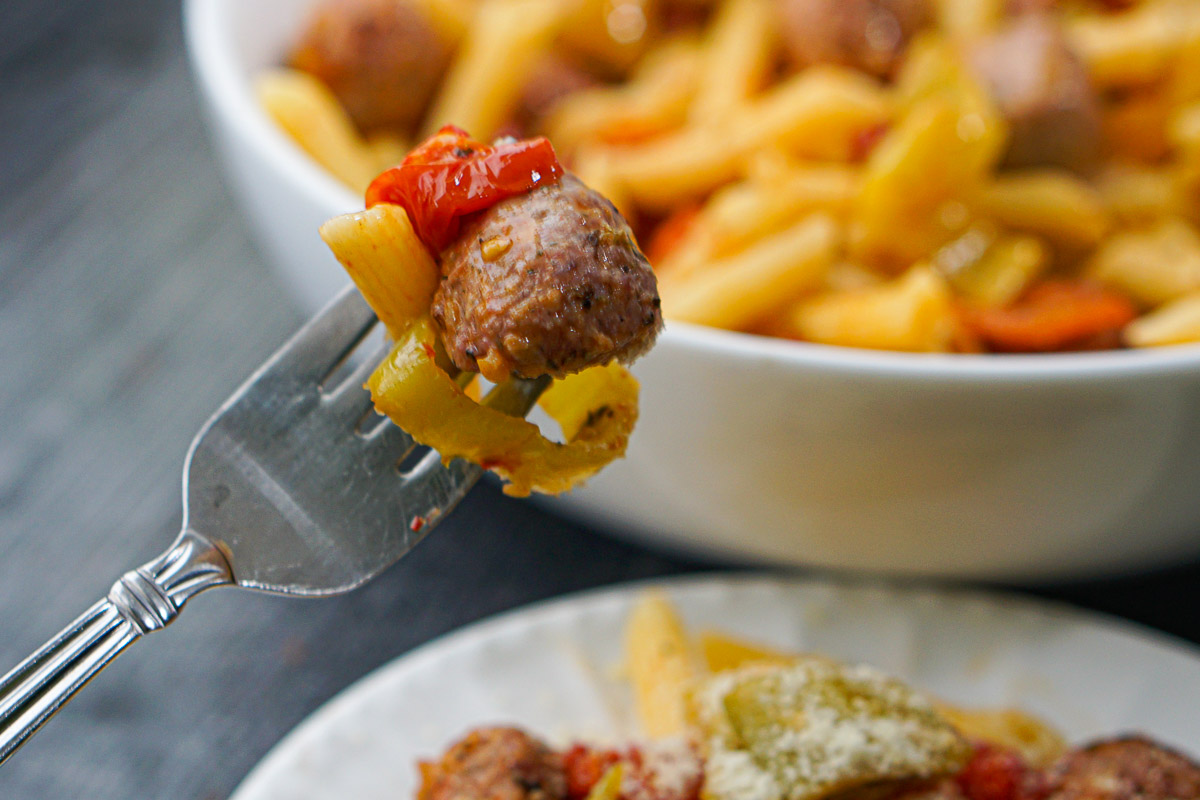 closeup of a forkful of sausage and pasta