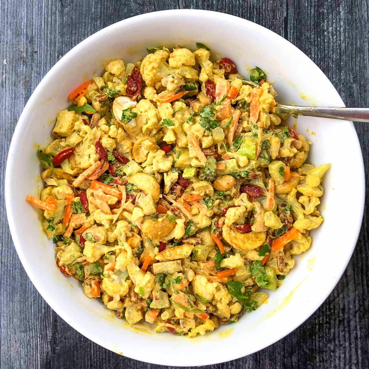 white bowl with curry cauliflower salad