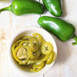 white ramekin with pickled jalapeno peppers