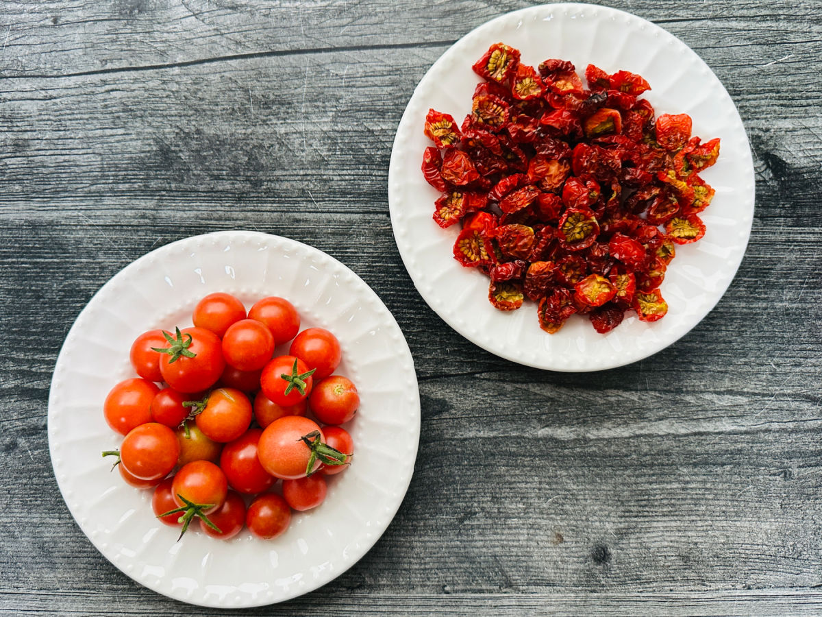White plates with both the raw small tomato and a plate with the finished dried ones.
