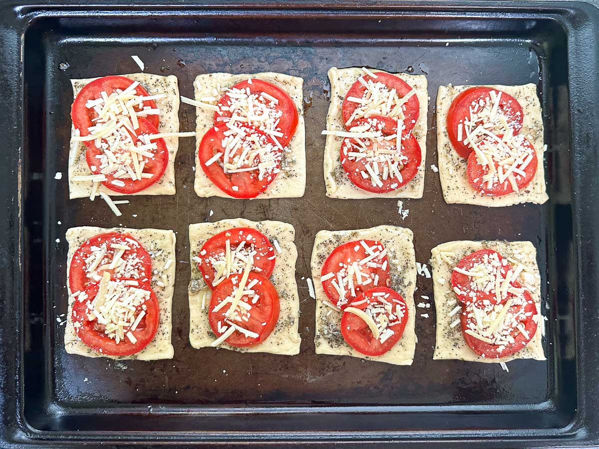 tarts covered with cheese ready to bake