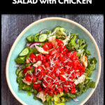 Aerial view of a aqua bowl with a high protein bruschetta salad with chicken and text.