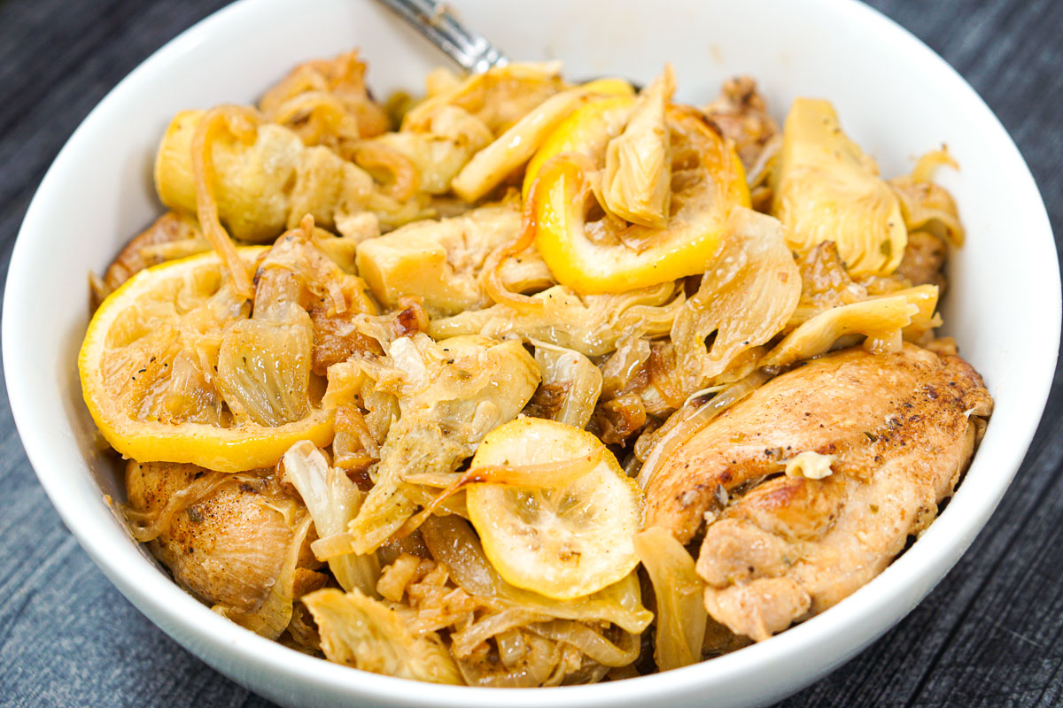 closeup of a bowl with all the chicken, lemon, artichokes and fennel dish