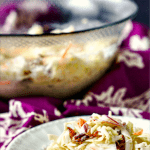 glass bowl and white plate with creamy southwestern keto coleslaw with text
