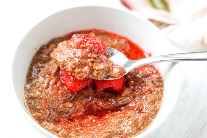a spoonful of chocolate keto oatmeal with raspberry syrup