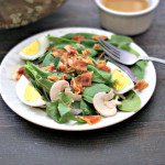 Classic spinach salad with bacon, eggs and veggies topped with a hot maple bacon dressing to make the perfect fall salad that is low carb and Paleo too!