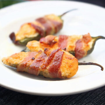 white plate with 3 bacon wrapped keto jalapeno poppers